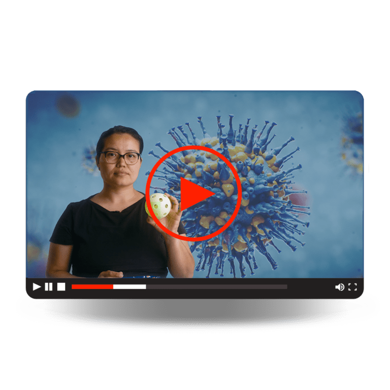 mRNA Vaccines Video - A woman holding a whiffle ball as a prop to explain viruses.